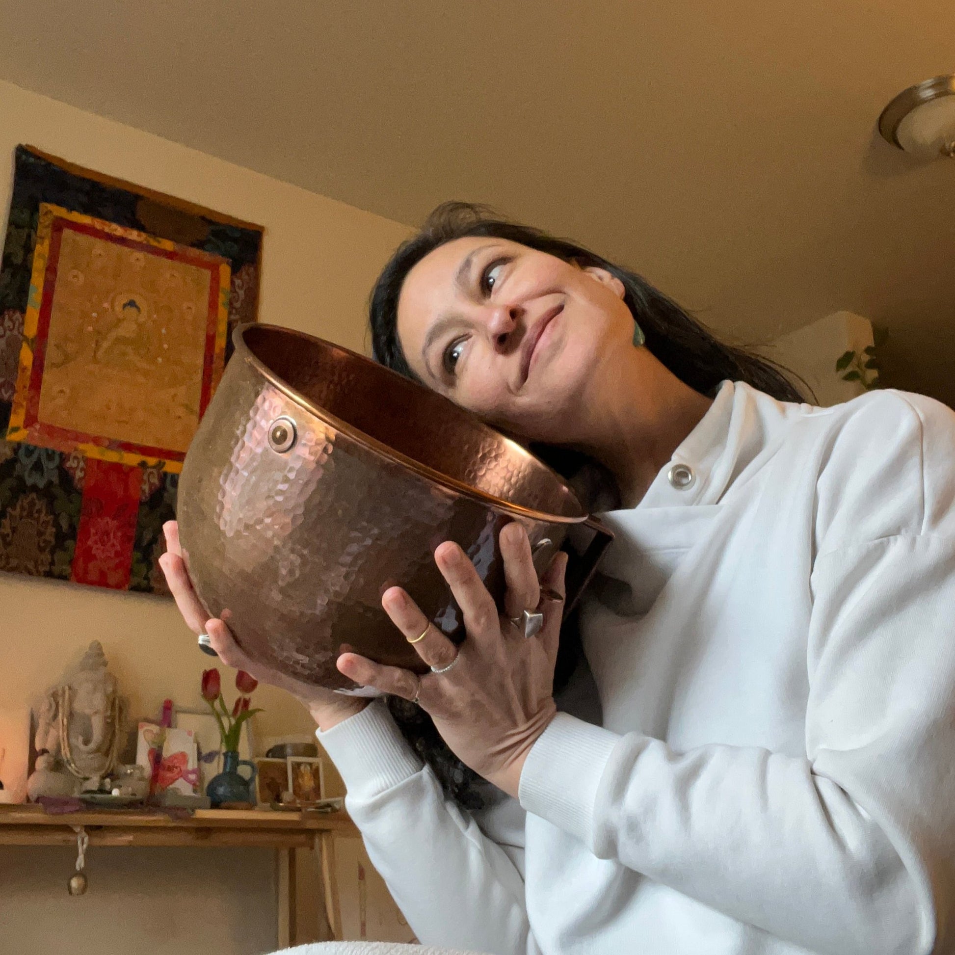 Amarylis Fernandez, lovingly holding her copper bowl used to wash the ghee and make her 100x Washed Ghee Ayurvedic Skin Cream.